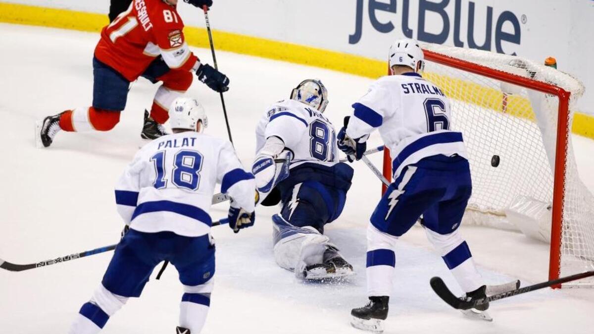 Jonathan Marchessault puts up the game-winning shot against former teammate Andrei Vasilevskiy as Anton Stralman and Ondrej Palat try and defend as the Florida Panthers beat the visiting Lightning 2-1 in overtime on Thursday night.