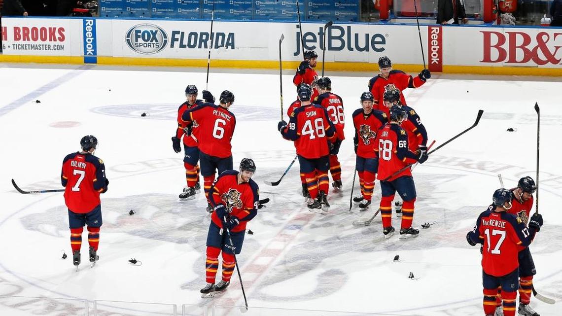 The Florida Panthers gather at center ice and raise their as the fans throw plastic rats onto the ice after their win against the Minnesota Wild at BB&T Center on Jan. 3, 2016.