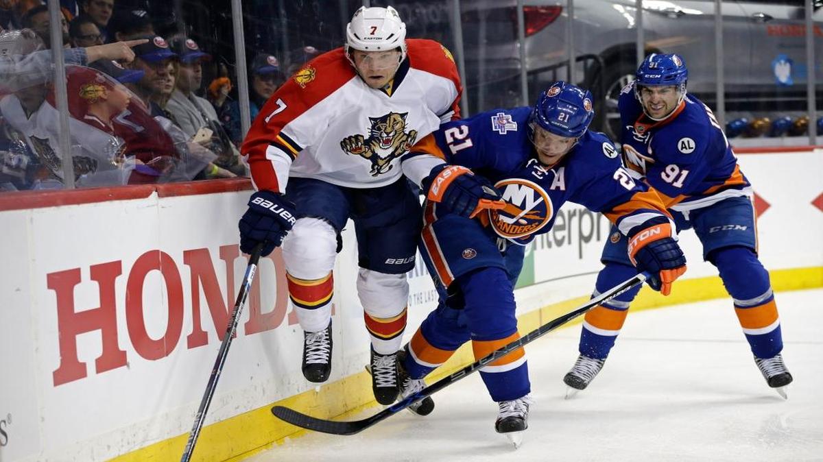Panthers defenseman Dmitry Kulikov, left, and Islanders right wing Kyle Okposo during Game 3 on Sunday night.