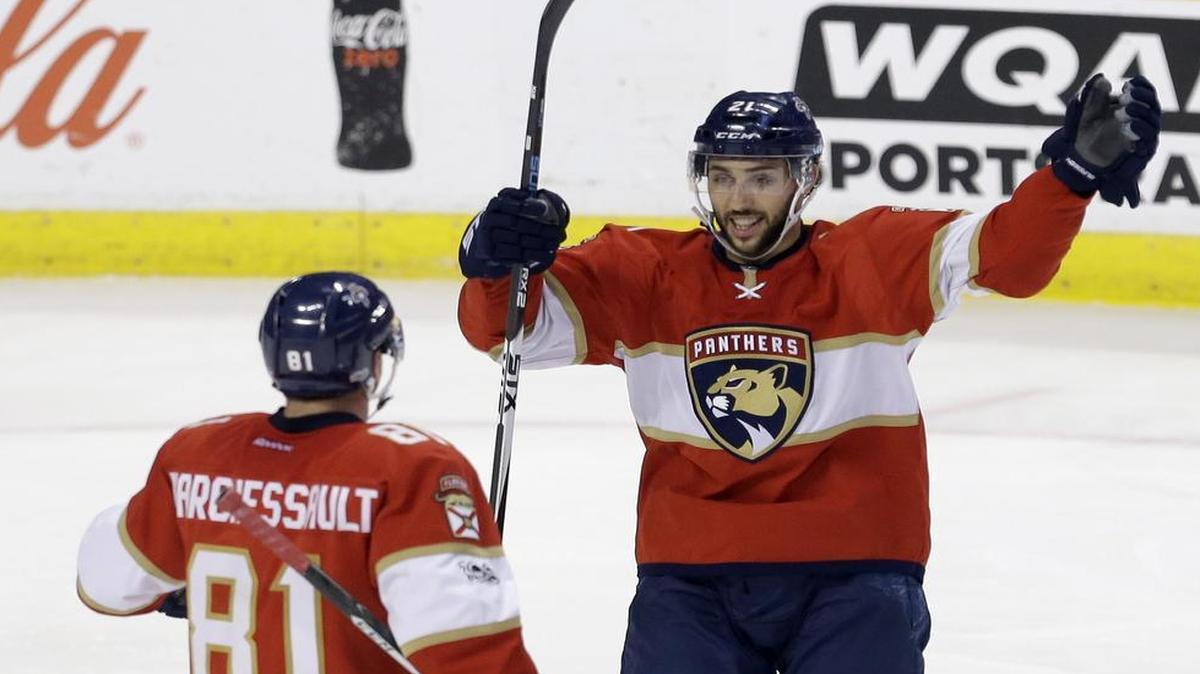 Florida Panthers center Vincent Trocheck (21) prepares to congratulate teammate Jonathan Marchessault (81) after he scored the game winning goal 2-1 against the Nashville Predators during the third period of an NHL hockey game, Friday, Jan. 6, 2017, in Sunrise, Fla.
