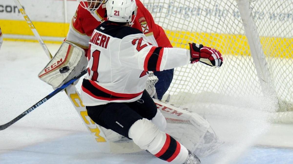 Panthers Roberto Luongo deflects a shot by New Jersey’s Kyle Palmieri (21) during the first period of their preseason game Saturday night in West Point, New York.