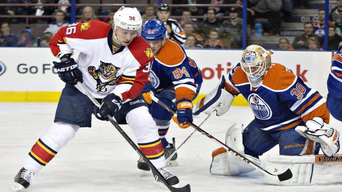 
Florida Panthers Jussi Jokinen (36) picks up the rebound as Edmonton Oilers goalie Ben Scrivens (30) makes the save and Oscar Klefbom (84) defends during first-period NHL hockey game action in Edmonton, Alberta, Sunday, Jan. 11, 2015.
