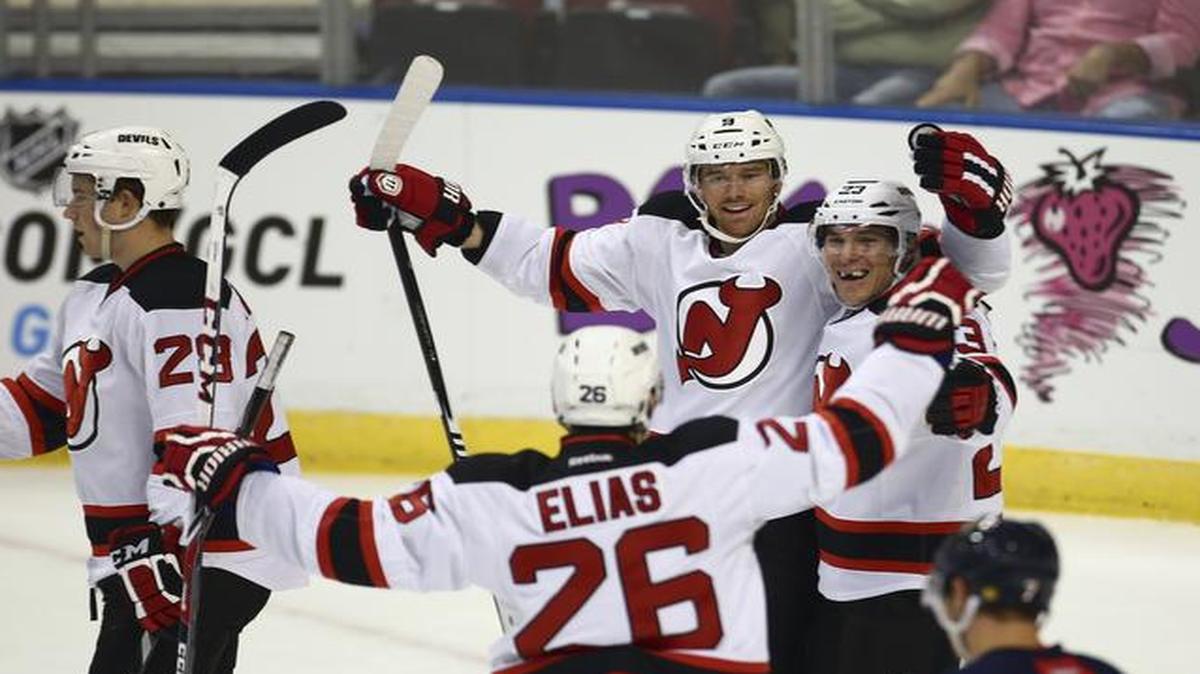 
New Jersey Devils players Martin Haviat (9), Mike Cammalleri (23) and Patrik Elias (26) celebrate a goal against the Florida Panthers during the first period of a NHL hockey game in Sunrise on Oct. 11, 2014.
