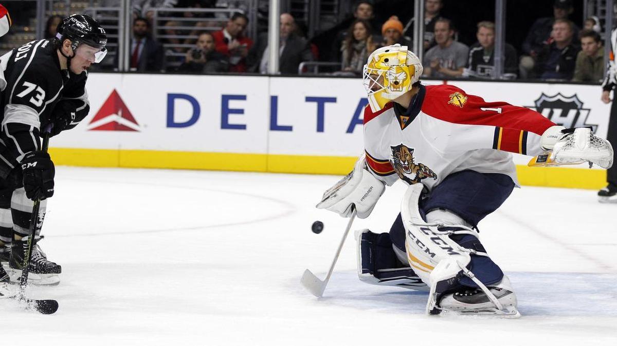 Florida Panthers goalie Roberto Luongo (1) deflects a shot by Los Angeles Kings center Tyler Toffoli (73) during the second period of an NHL hockey game in Los Angeles, Saturday, Nov. 7, 2015.