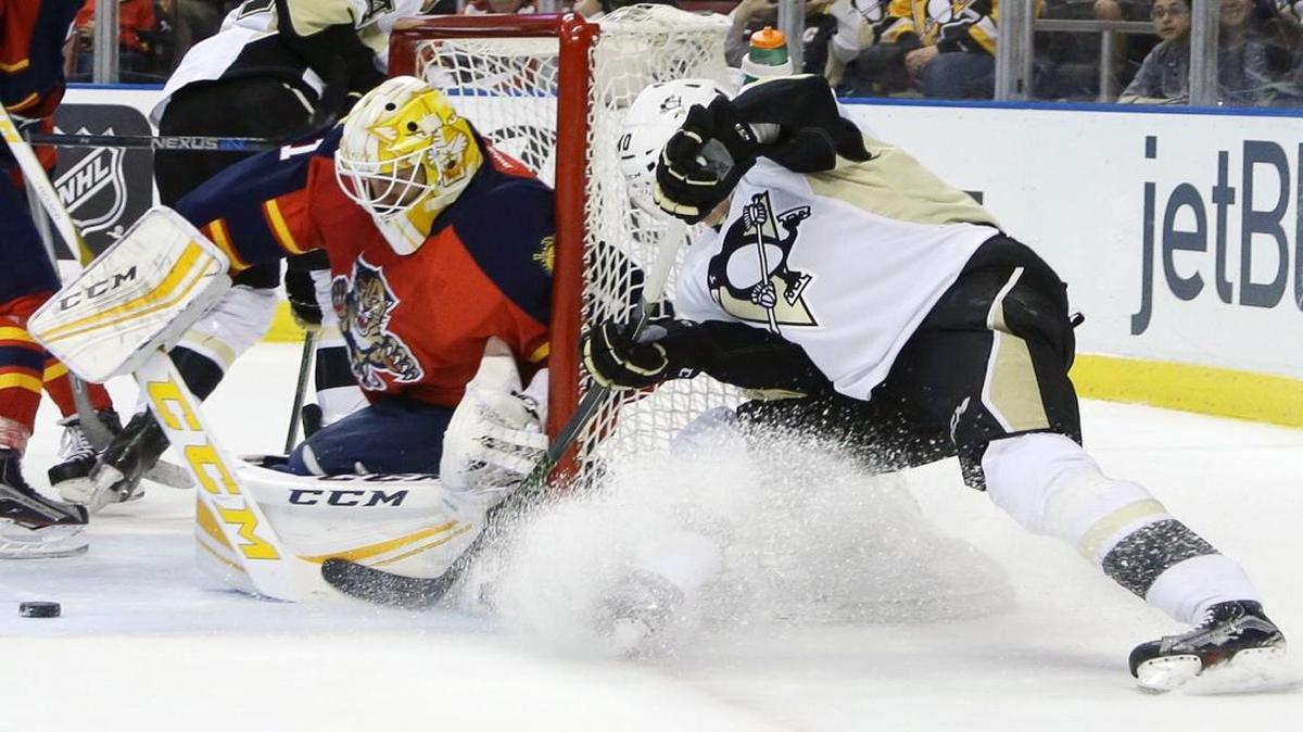 Pittsburgh Penguins center Oskar Sundqvist, right, attempts a shot on the goal as Florida Panthers goalie Roberto Luongo, left, defends during the first period of an NHL hockey game, Saturday, Feb. 6, 2016, in Sunrise, Fla.