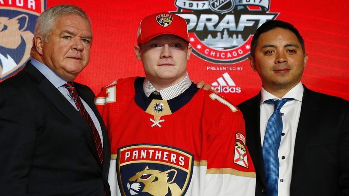 Owen Tippett, center, wears a Florida Panthers jersey after being selected by the team in the first round of the NHL hockey draft, Fri., June 23, 2017, in Chicago.