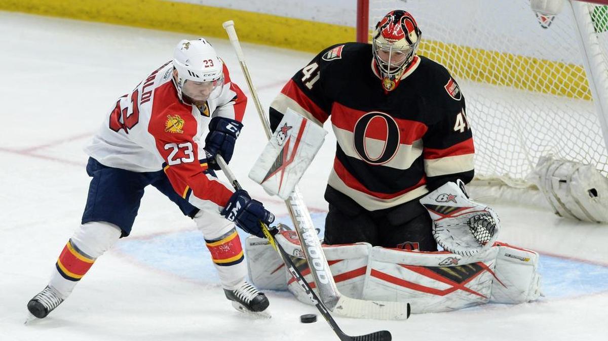 Ottawa Senators goalie Craig Anderson keeps his eye on the puck as Florida Panthers center Rocco Grimaldi deflects a shot during the third period of an NHL hockey game, Thurs., April 7, 2016 in Ottawa, Ontario.