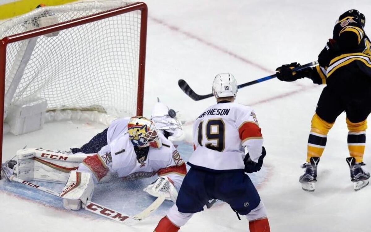 Boston Bruins right wing David Pastrnak, right, shoots his game-winning goal over Florida Panthers goalie Roberto Luongo (1) during the overtime period of an NHL hockey game in Boston, Mon., Dec. 5, 2016. The Bruins won 4-3. At right is Panthers defenseman Michael Matheson.