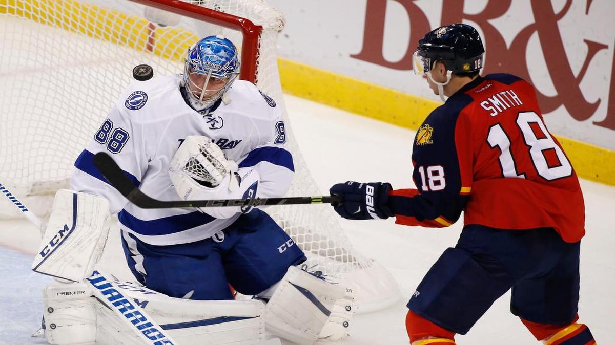 Panthers winger Reilly Smith attempts to hit the puck past Lightning goalie Andrei Vasilevskiy during the second period at BB&T Center. Aaron Ekblad won it for Florida on a goal with 20.2 seconds left.
