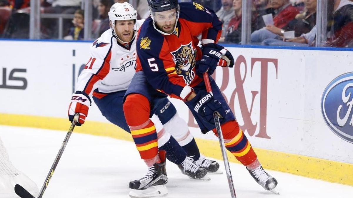 Florida Panthers defenseman Aaron Ekblad (5) and Washington Capitals center Brooks Laich (21) battle for the puck during the first period Thursday, Dec. 10, 2015 in Sunrise, Fla.