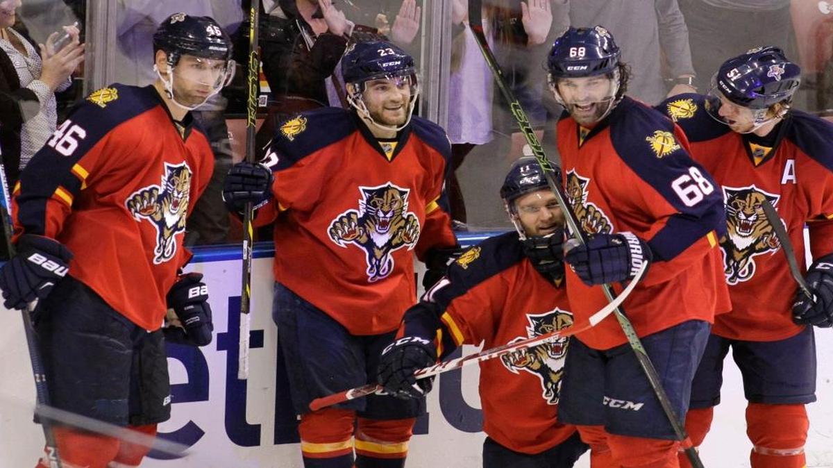 Florida Panthers’ Jonathan Huberdeau, third from left, celebrates with teammates Jakub Kindl (46), of the Czech Republic, Rocco Grimaldi, second from left, Jaromir Jagr (68), of the Czech Republic, and Brian Campbell, right, after scoring a goal during the third period of an NHL hockey game against the New Jersey Devils, Thursday, March 31, 2016, in Sunrise, Fla. The Panthers won 3-2.