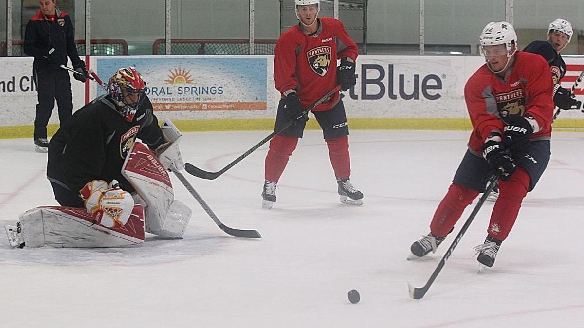 Florida goalie Mike McKenna works against Jonathan Marchessault and Richards Bukarts at training camp last Friday.
