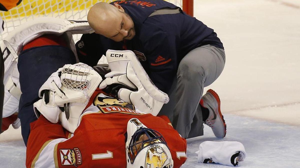 Florida Panthers head athletic trainer Dave DiNapoli attends to goalie Roberto Luongo on Dec. 4.