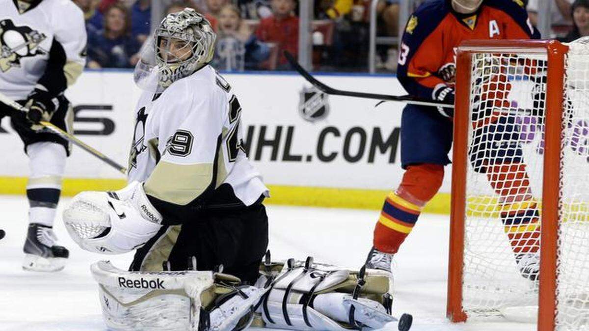 
Pittsburgh Penguins goalie Marc-Andre Fleury (29) watches as the puck goes in for a goal by Florida Panthers' Jussi Jokinen during the second period of an NHL hockey game, Monday, Dec. 22, 2014, in Sunrise, Fla.
