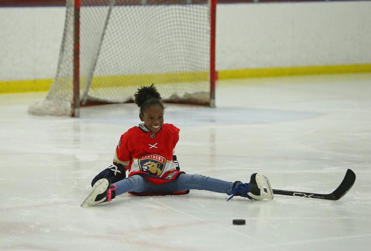 Eleven-year-old Jessica King of Barbados smiles during the private hockey clinic by former Florida Panthers player and now vice president of business operations Shawn Thornton at the Florida Panthers IceDen in Coral Springs on Wednesday, December 6, 2017. Thornton met Jessica in August when they hosted the first ice hockey clinic in the Caribbean on a synthetic ice rink in Barbados.