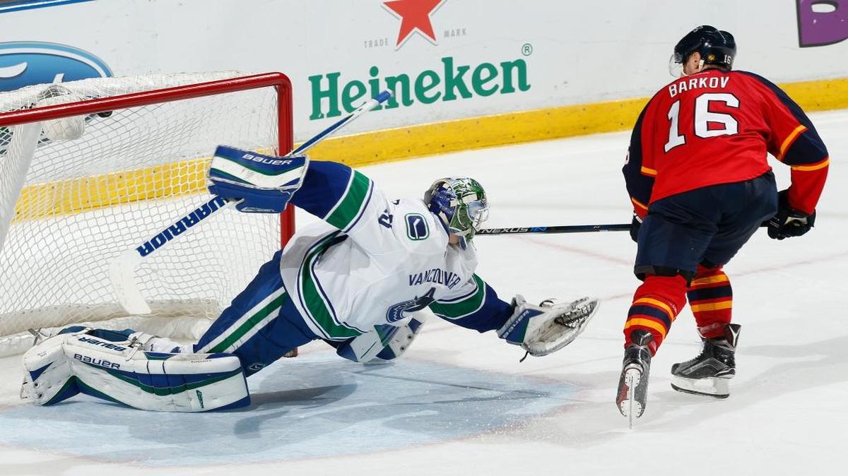 Florida Panthers forward Aleksander Barkov (16) scores the winning goal past Vancouver Canucks goaltender Jacob Markstrom (25) during the shootout period of an NHL hockey game, Sunday, Dec. 20, 2015, in Sunrise, Fla. The Panthers defeated the Canucks 5-4.