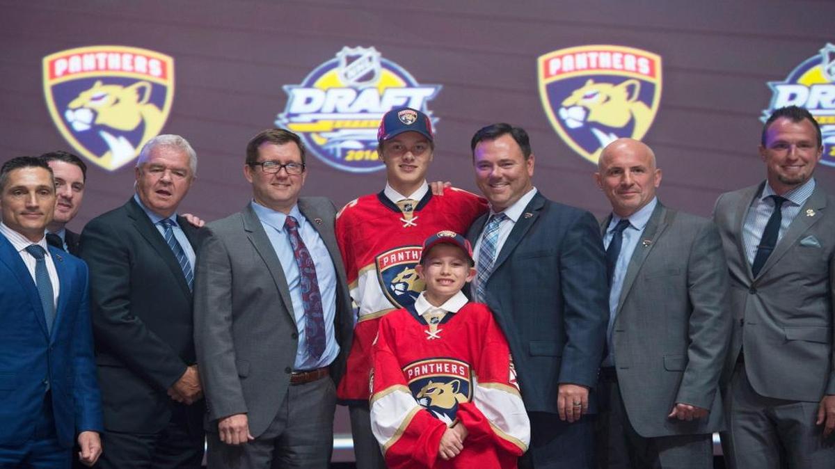 Henrik Borgstrom, center, stands on stage with members of the Florida Panthers management team at the NHL hockey draft, Fri., June 24, 2016, in Buffalo, N.Y.