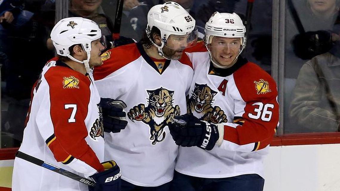 Florida Panthers’ Dmitry Kulikov (7), Jaromir Jagr (68) and Jussi Jokinen (36) celebrate after Jagr scored against the Winnipeg Jets during the third period of an NHL hockey game Tuesday, March 1, 2016, in Winnipeg, Manitoba.