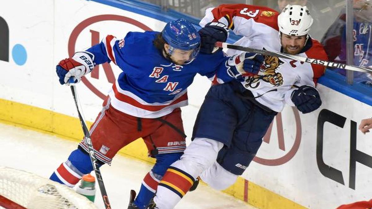 
New York Rangers' Mats Zuccarello, left, checks Florida Panthers' Willie Mitchell during the third period of an NHL hockey game Sunday, March 15, 2015, at Madison Square Garden in New York. The Rangers won 2-1. 
