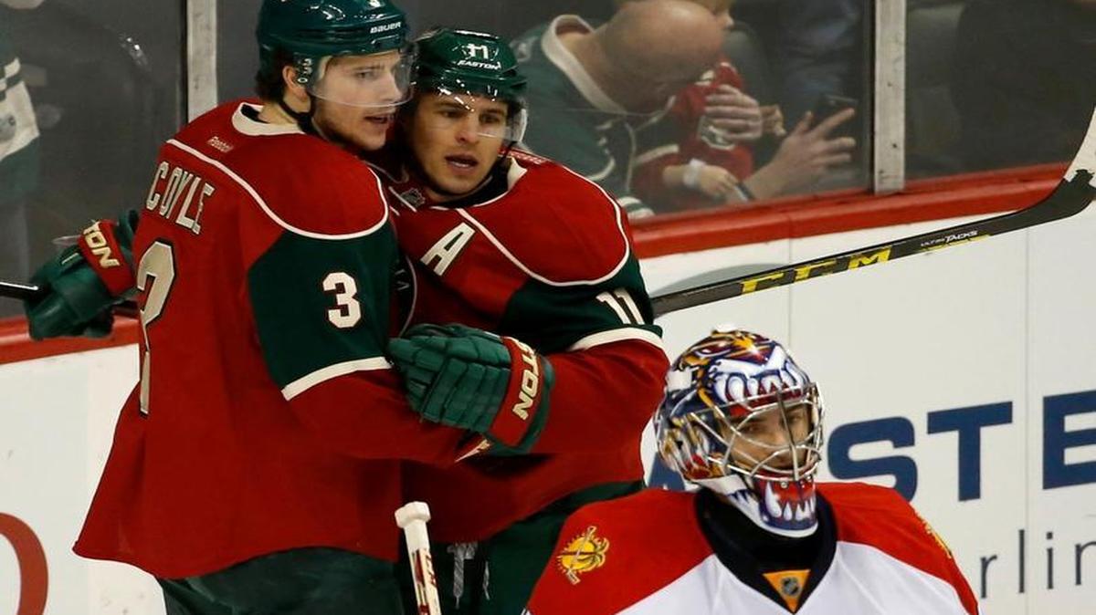 Minnesota Wild center Charlie Coyle (3) and Wild left wing Zach Parise, right, celebrate a goal by Coyle as Florida Panthers goalie Al Montoya (35) looks away during the first period of an NHL hockey game in St. Paul, Minn., Sunday, Feb. 28, 2016.