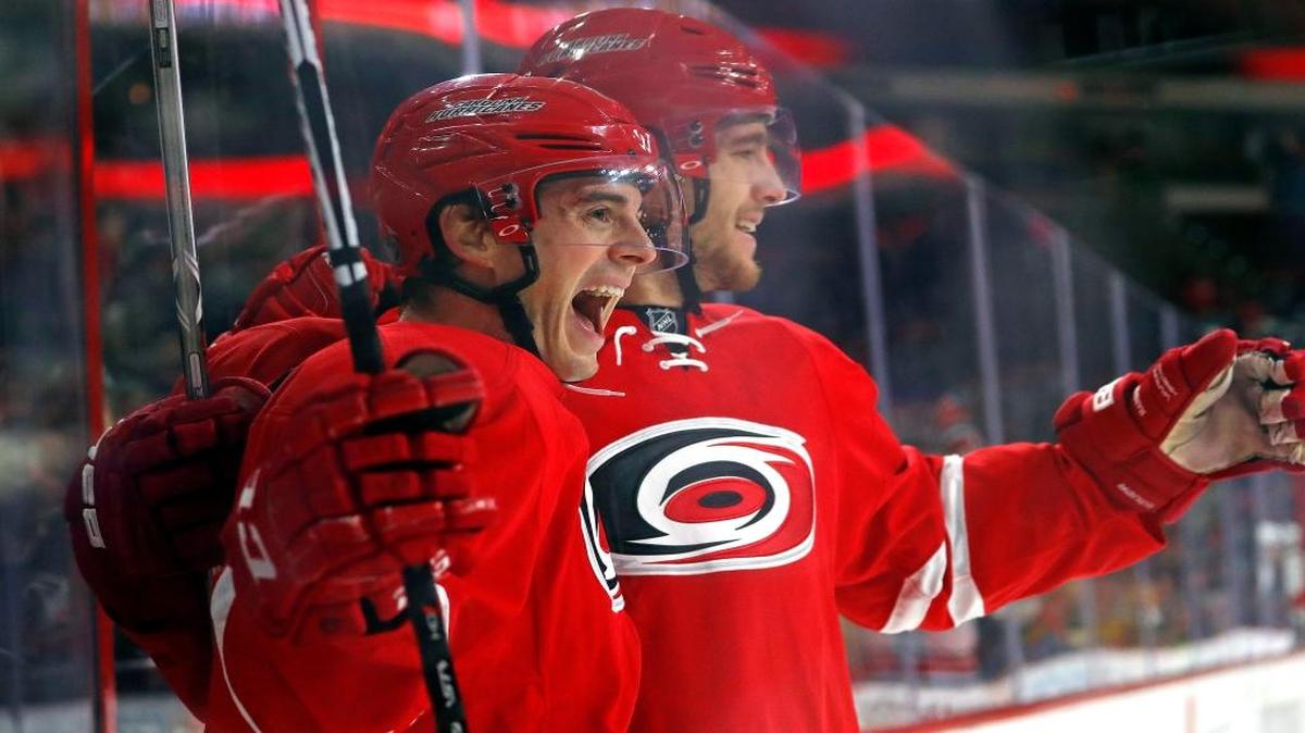 Carolina Hurricanes' Derek Ryan (33) celebrates his goal with teammate Noah Hanifin (5) during the second period of an NHL hockey game against the Florida Panthers on Nov. 27, 2016, in Raleigh, N.C. The Hurricanes won 3-2.