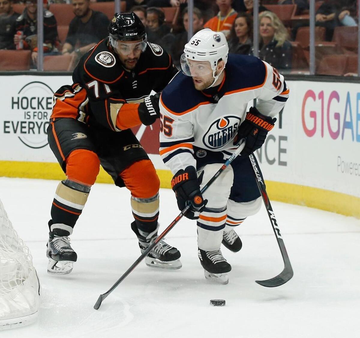 Edmonton Oilers center Mark Letestu, right, takes the puck behind the net under pressure by Anaheim Ducks right wing J.T. Brown in Anaheim, Calif., Friday, Feb. 9, 2018.