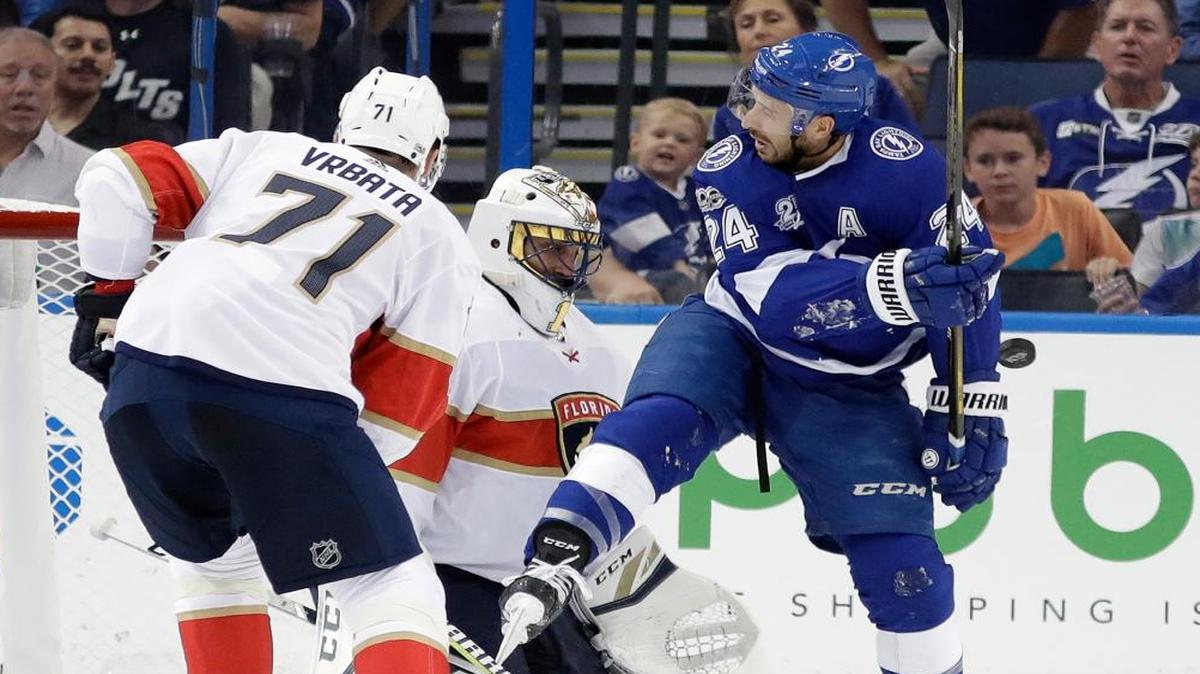 Tampa Bay Lightning right wing Ryan Callahan (24) gets hit with a slap shot in front of Florida Panthers goalie Roberto Luongo and right wing Radim Vrbata (71), of the Czech Republic, during the first period of an NHL hockey game Fri., Oct. 6, 2017, in Tampa, Fla.