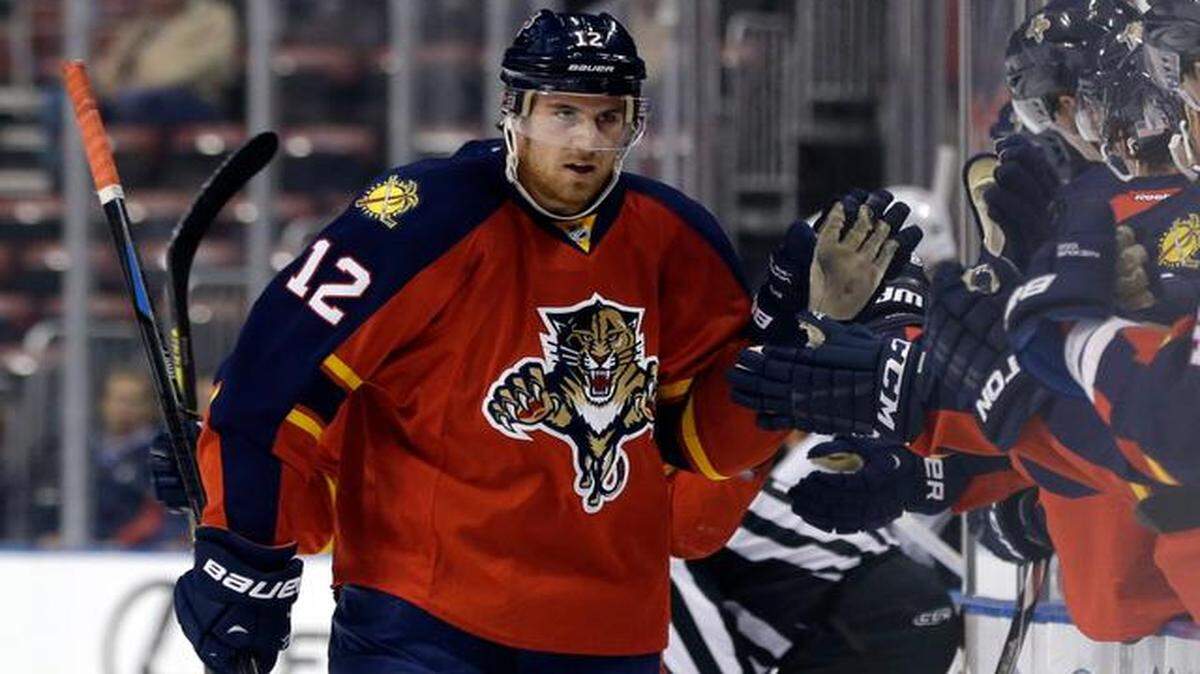 Big Congrats:  Jimmy Hayes is greeted after scoring a goal against the Sharks on Tuesday.