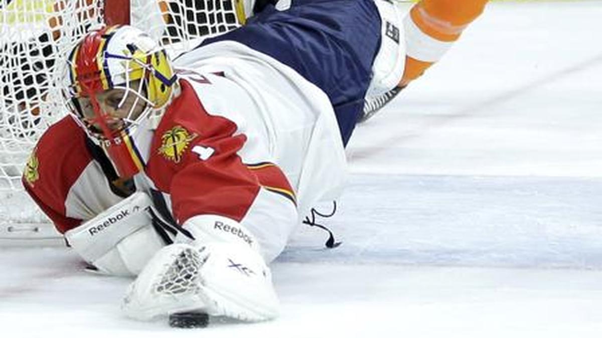 
Florida Panthers' Roberto Luongo, left, dives to cover up a loose puck as Philadelphia Flyers' Zac Rinaldo skates in during the second period of an NHL hockey game, Thursday, Nov. 6, 2014, in Philadelphia. 
