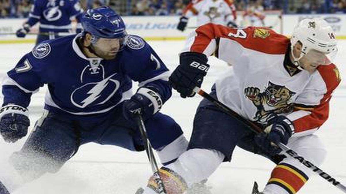 
Applying the brakes: Left wing Tomas Fleischmann of the Panthers, right, changes direction to get away from Lightning defenseman Radko Gudas. 
