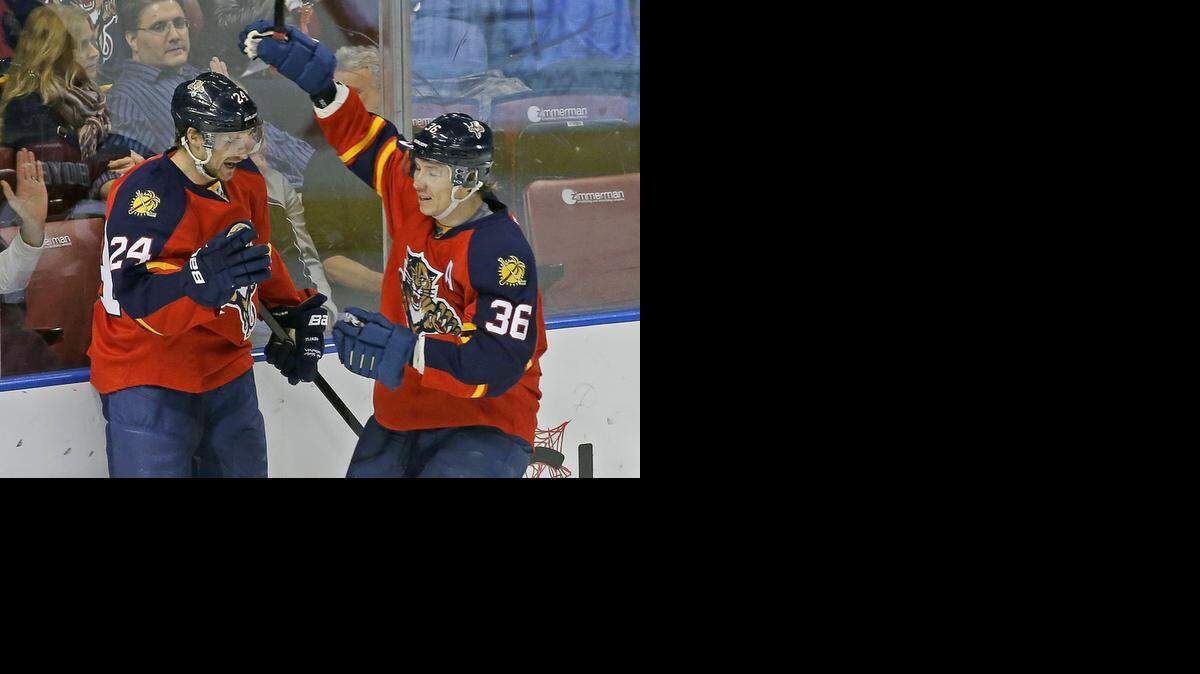 
Florida Panthers right wing Brad Boyes (24) celebrates his goal with teammate Jussi Jokinen (36) against the Buffalo Sabres during the first period of an NHL hockey game, Saturday, Dec. 6, 2014, in Sunrise, Fla. 
