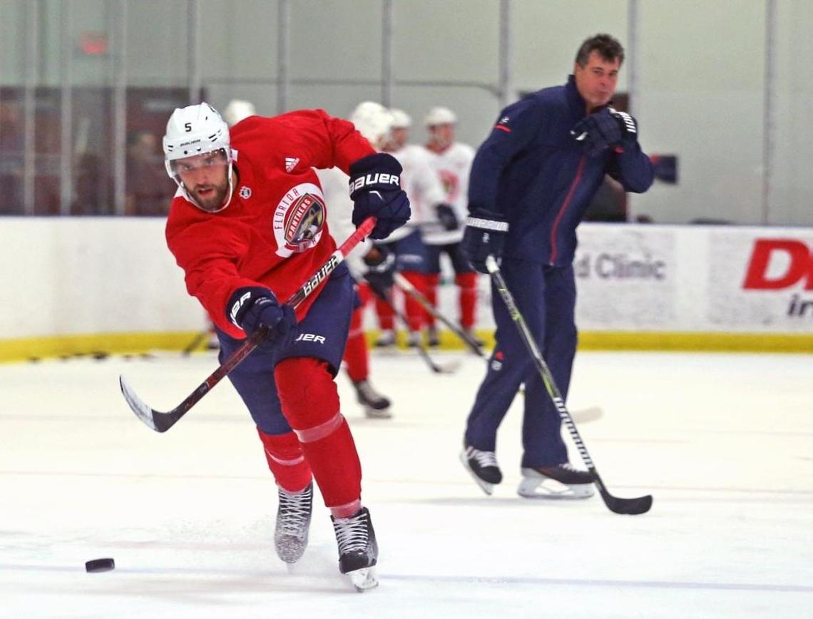 Former New York Islanders coach and new Florida Panthers assistant Jack Capuano watches defenseman Aaron Ekblad shoot during the first day of training camp on Friday morning.