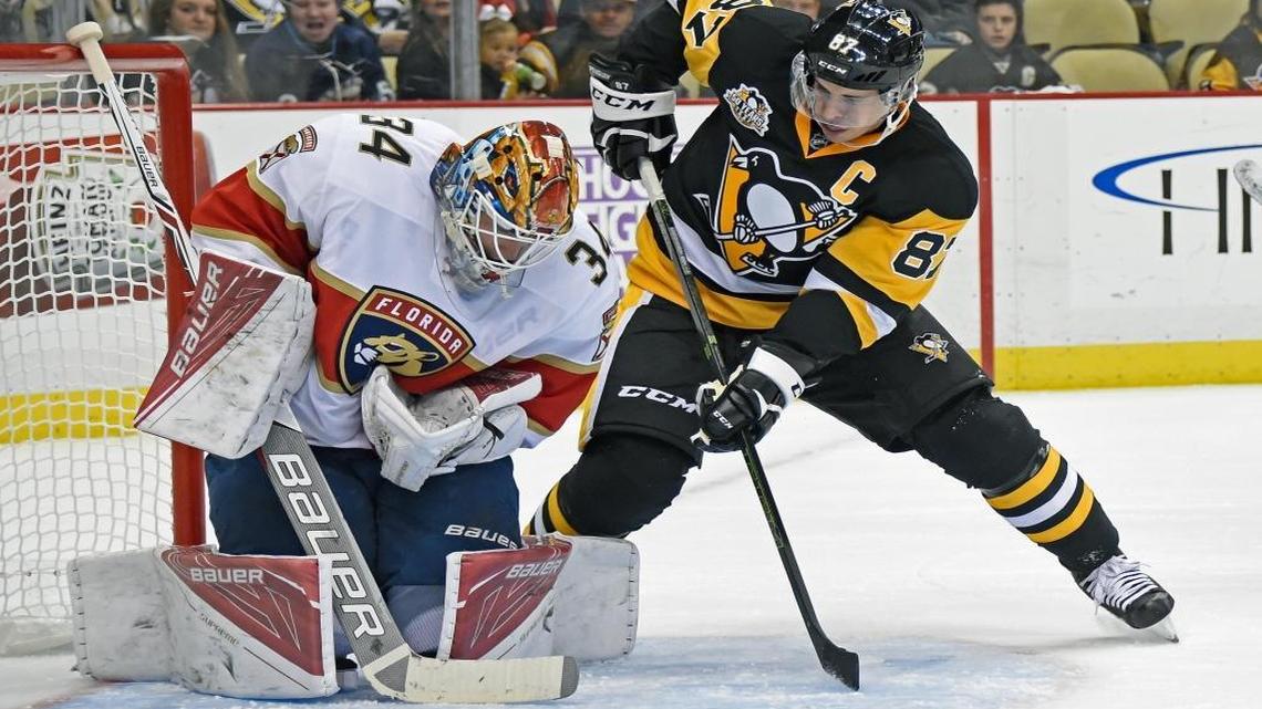 Florida Panthers goalie James Reimer (34) makes a save as Pittsburgh Penguins center Sidney Crosby (87) waits for a rebound during the second period of an NHL hockey game on Tues., Oct. 25, 2016, in Pittsburgh.