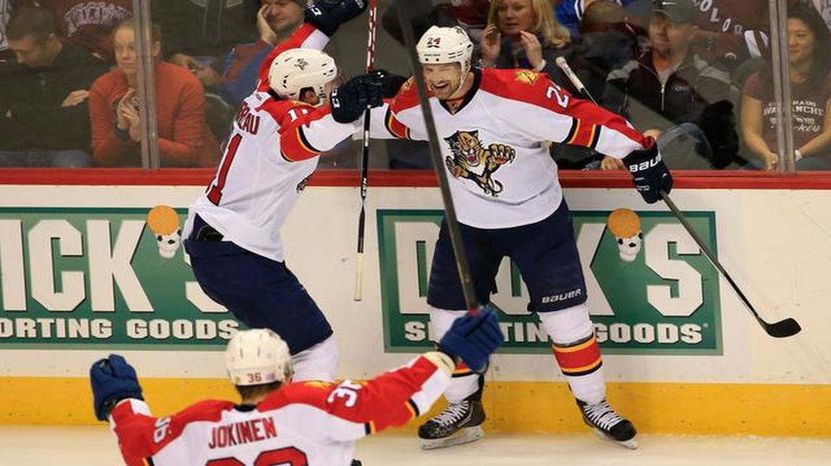 
 Brad Boyes #24 of the Florida Panthers celebrates his game winning goal in overtime with Jonathan Huberdeau #11 and Jussi Jokinen #36 of the Florida Panthers against goalie Reto Berra #20 of the Colorado Avalanche at Pepsi Center on October 21, 2014 in Denver, Colorado. The Panthers defeated the Avalanche 4-3 in overtime. 
