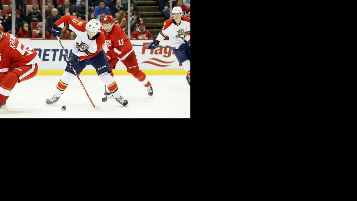 
Florida Panthers center Jonathan Huberdeau (11) shoots against the Detroit Red Wings in the first period of an NHL hockey game in Detroit Friday, Dec. 12, 2014. 
