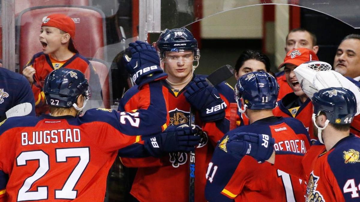 Florida Panthers center Aleksander Barkov, center, is congratulated by teammates after a video review showed that he scored a goal during the second period of an NHL hockey game against the Dallas Stars, Saturday, Oct. 17, 2015, in Sunrise, Fla.