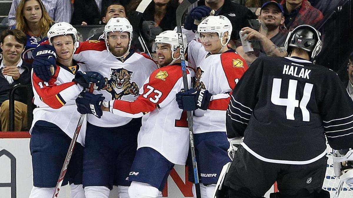 Florida Panthers’ Jonathan Huberdeau (11), Aaron Ekblad (5), Brandon Pirri (73) and Aleksander Barkov (16) celebrate a goal by Barkov as New York Islanders goalie Jaroslav Halak (41) reacts during the second period Tuesday, Dec. 15, 2015, in New York.