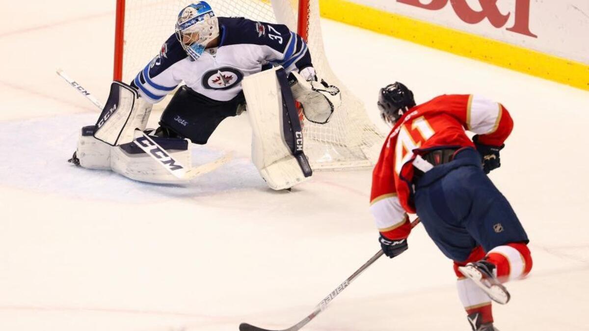 Greg McKegg scores Florida’s lone goal against Winnipeg goalie Connor Hellebuyck in Wednesday’s 4-1 loss to the Jets at BB&T Center.