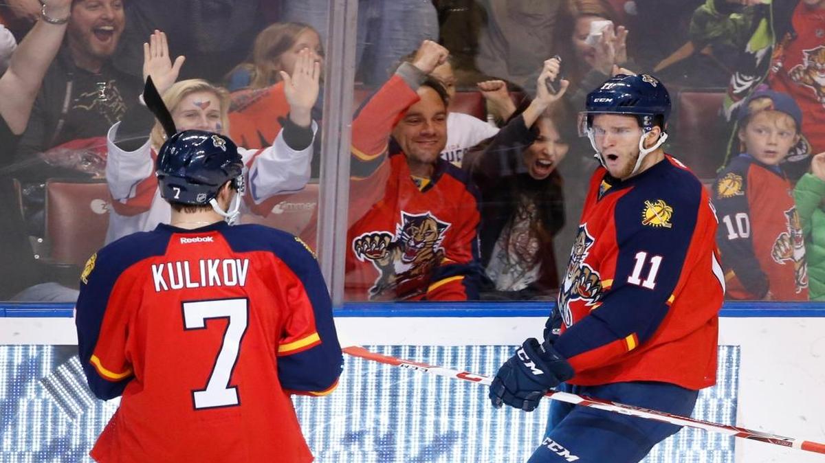 Florida Panthers left wing Jonathan Huberdeau (11) celebrates with defenseman Dmitry Kulikov (7) after scoring a goal during the second period of an NHL hockey game against the Tampa Bay Lightning, Saturday, Jan. 23, 2016 in Sunrise, Fla.