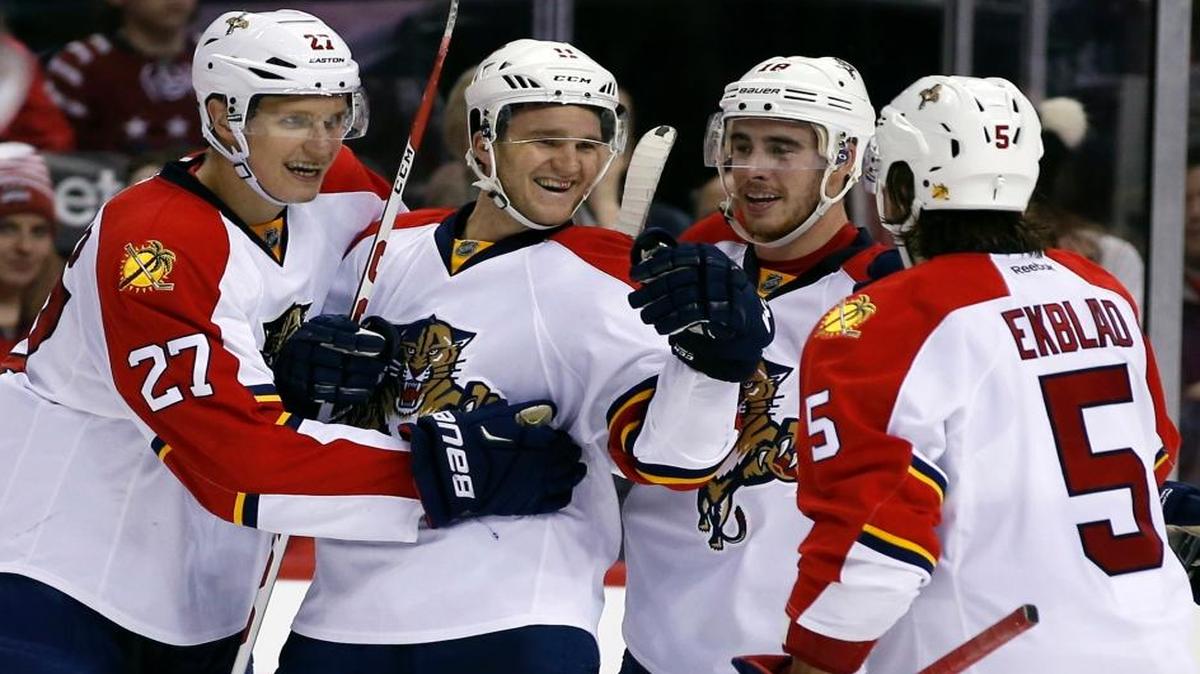 Florida Panthers center Nick Bjugstad (27), center Jonathan Huberdeau (11), right wing Reilly Smith (18) and defenseman Aaron Ekblad (5) celebrate a goal by Huberdeau during the second period against the Washington Capitals, Tuesday, Feb. 2, 2016, in Washington.