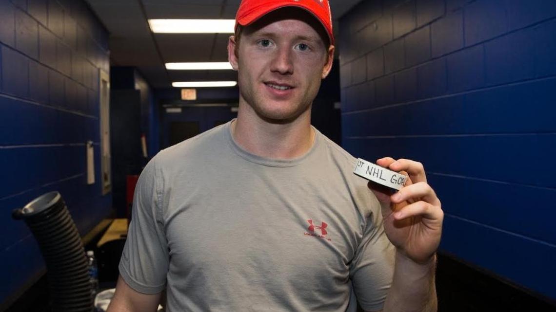 Mike Matheson poses with the puck from his first NHL goal outside the Amalie Arena locker room in Tampa on Tuesday night.
