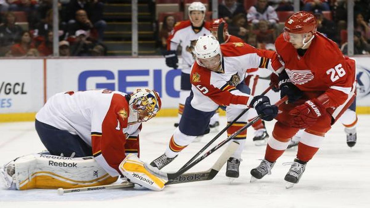 
Florida Panthers goalie Roberto Luongo (1) stops Detroit Red Wings right wing Tomas Jurco (26) shot as Florida Panthers defenseman Aaron Ekblad (5) defends in the second period during an NHL hockey game in Detroit Tuesday, Dec. 2, 2014. 
