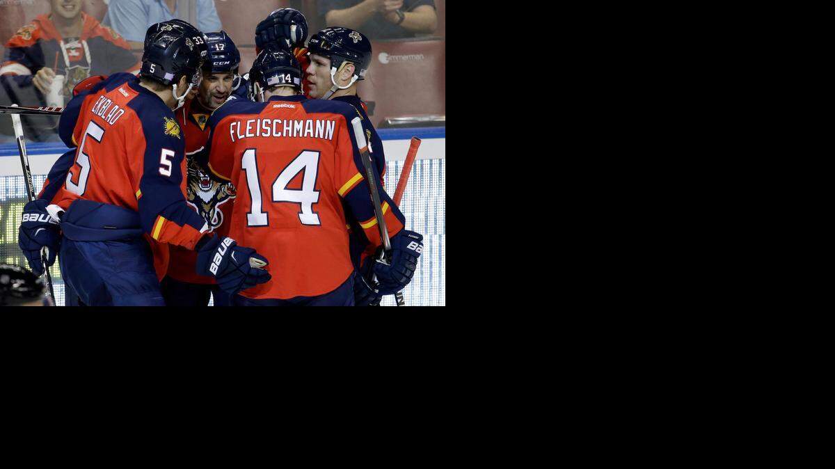 
Building a lead: The Panthers celebrate after Derek MacKenzie’s goal put them ahead 3-0. 
