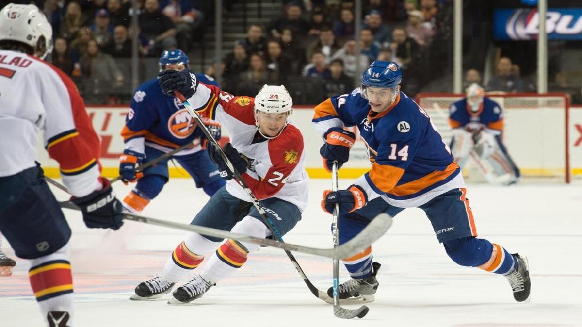 Florida Panthers left wing Jiri Hudler (24) and New York Islanders defenseman Thomas Hickey (14) skate after the puck in the second period of an NHL hockey game in New York, Monday, March 14, 2016.