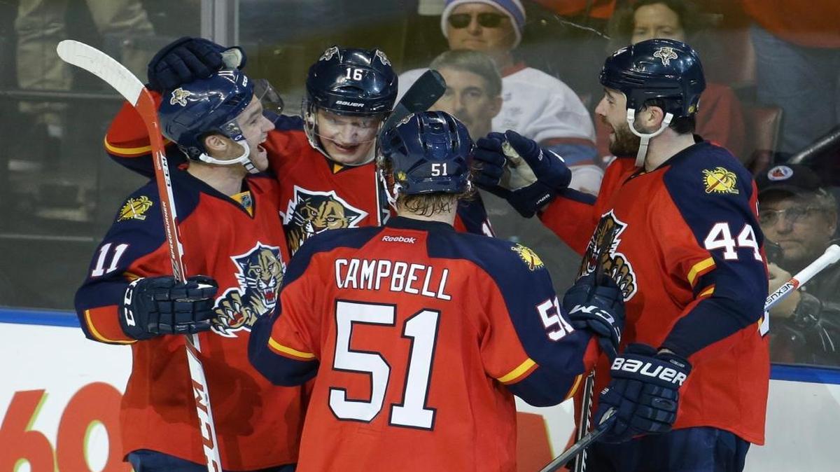Florida Panthers center Aleksander Barkov (16) is congratulated by center Jonathan Huberdeau (11), defenseman Brian Campbell (51) and defenseman Erik Gudbranson (44) after scoring a goal during the third period of an NHL hockey game against the Montreal Canadiens, Tuesday, Dec. 29, 2015, in Sunrise, Fla. The Panthers defeated the Canadiens 3-1.