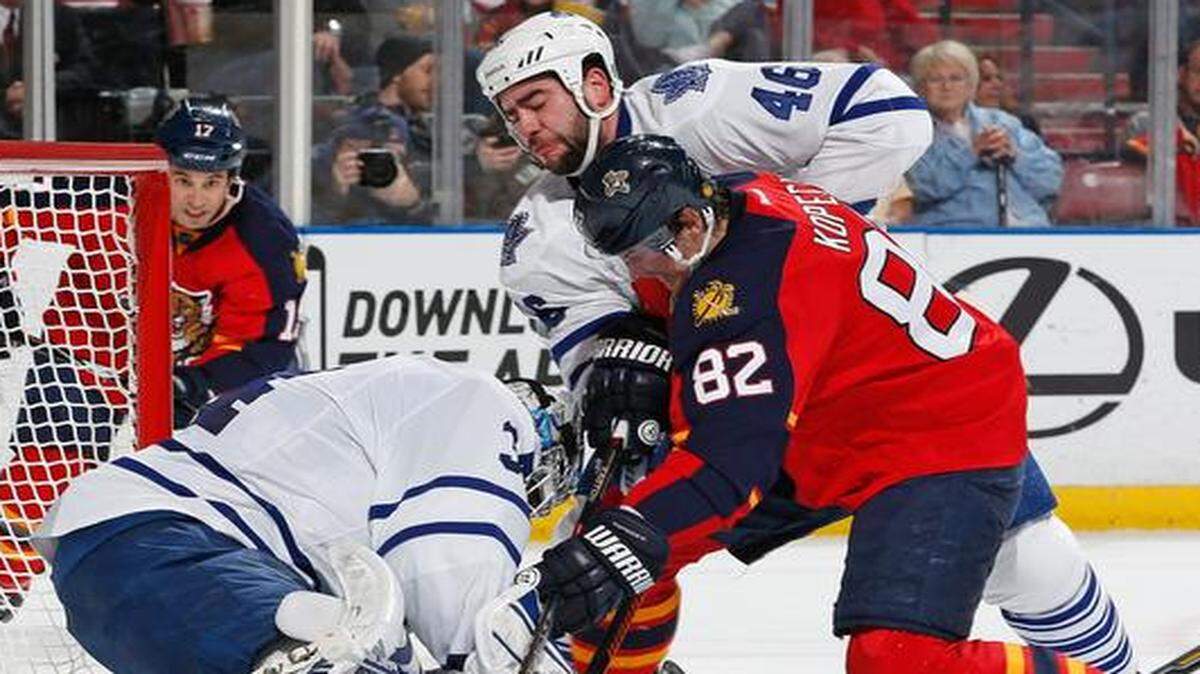 
Goaltender James Reimer stops a shot as Roman Polak of the Toronto Maple Leafs defends against Tomas Kopecky (82) of the Florida Panthers at the BB&T Center on Dec. 28, 2014 in Sunrise, Florida.
