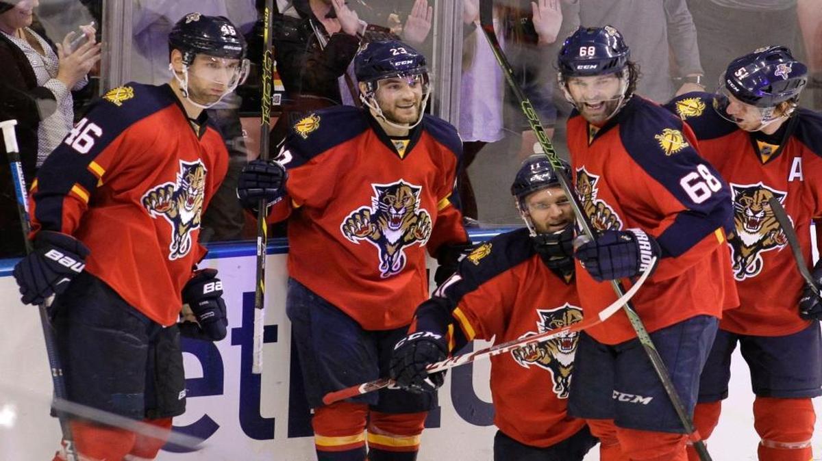 Florida Panthers’ Jonathan Huberdeau, third from left, celebrates with teammates Jakub Kindl (46), of the Czech Republic, Rocco Grimaldi, second from left, Jaromir Jagr (68), of the Czech Republic, and Brian Campbell, right, after scoring a goal during the third period of an NHL hockey game against the New Jersey Devils, Thursday, March 31, 2016, in Sunrise, Fla. The Panthers won 3-2.