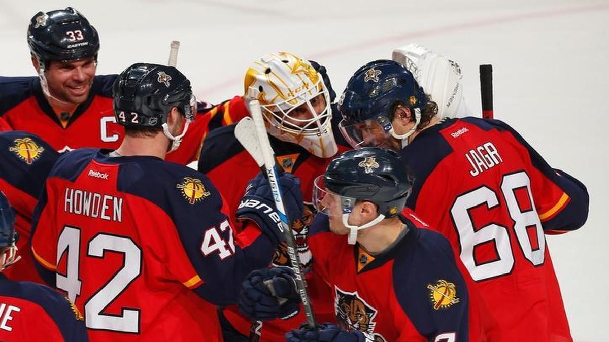 Florida Panthers goaltender Roberto Luongo (1) is congratulated by forward Jaromir Jagr (68), forward Quentin Howden (42), and defenseman Willie Mitchell (33) at the conclusion of the shoot-out of an NHL hockey game against the Ottawa Senators, Tuesday, Dec. 22, 2015, in Sunrise, Fla. The Panthers defeated the Senators 2-1.