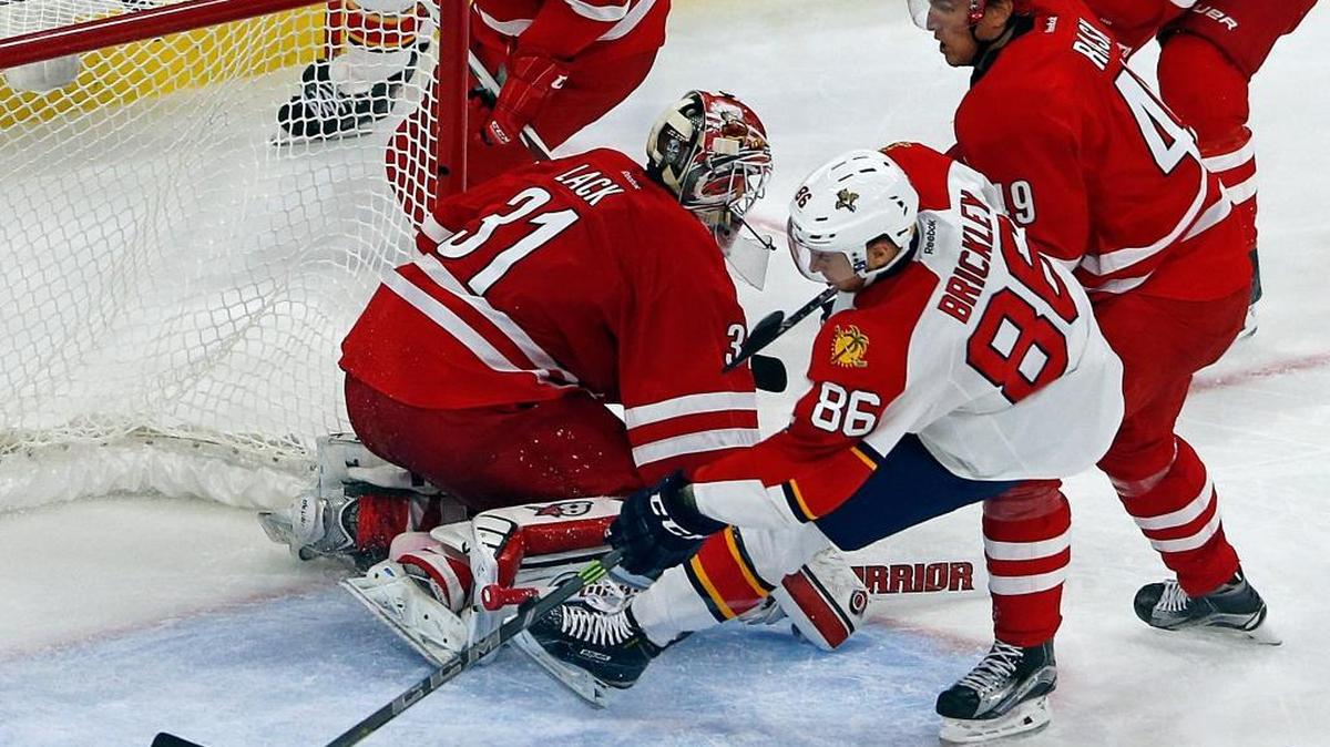 
Florida Panthers' Connor Brickley (86) picks up the loose puck from Carolina Hurricanes goalie Eddie Lack (31) to score a goal during the third period of an NHL hockey game with Victor Rask (49) nearby, Tuesday, Oct. 13, 2015, in Raleigh, N.C. The Panthers won 4-1.
