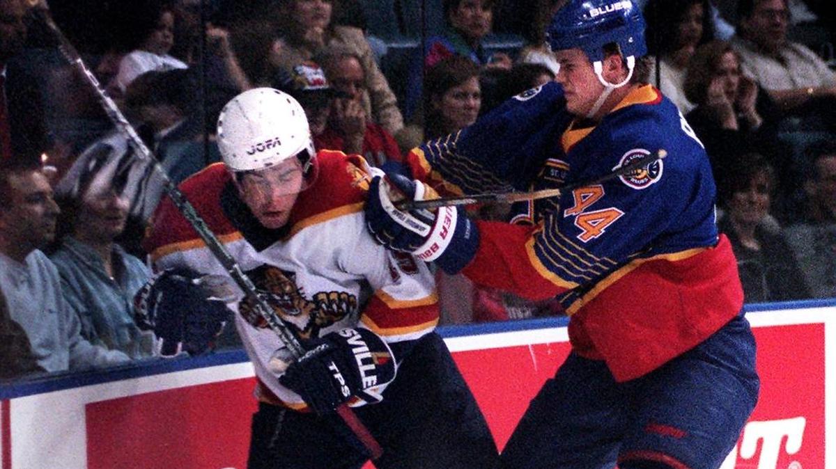 St. Louis defenseman Chris Pronger checks Florida forward Radek Dvorak at Miami Arena in 1997.